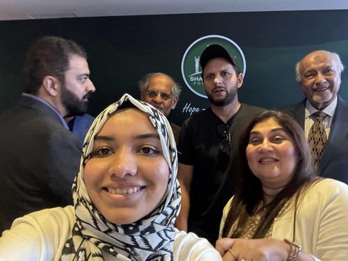 A group of people posing for a photo
Description automatically generated