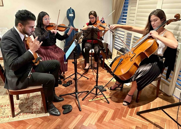 A group of people playing instruments

Description automatically generated