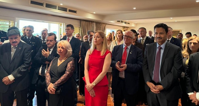 A group of people standing in a room

Description automatically generated