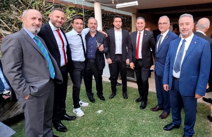 A group of men standing in a circle

Description automatically generated