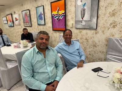 A group of men sitting at a table

Description automatically generated