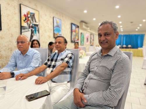 A group of men sitting in chairs

Description automatically generated