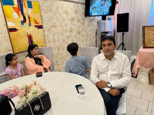 A group of people sitting at a table

Description automatically generated