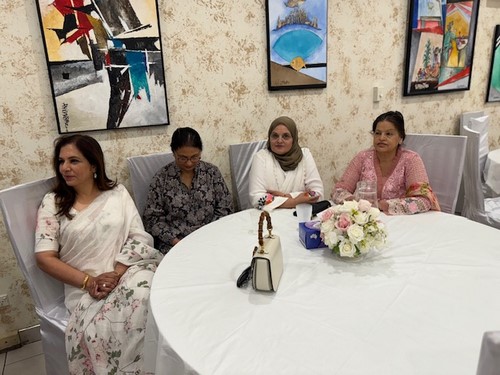 A group of women sitting at a table

Description automatically generated