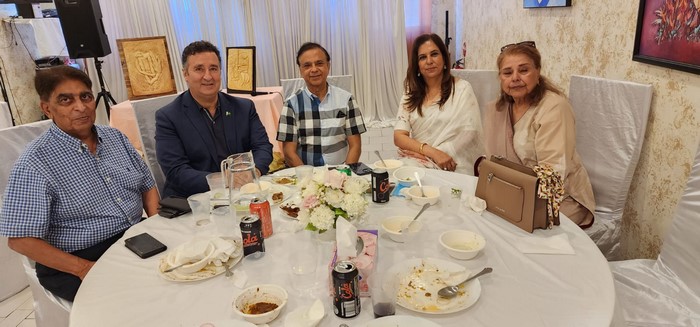 A group of people sitting at a table

Description automatically generated