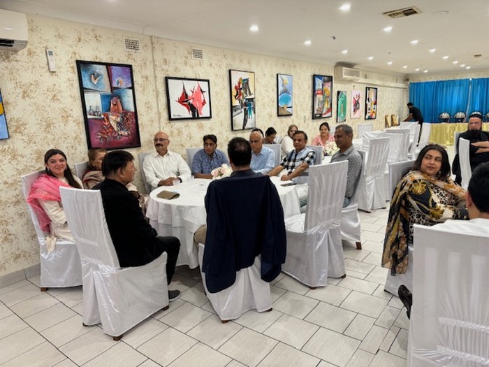 A group of people sitting at a round table

Description automatically generated