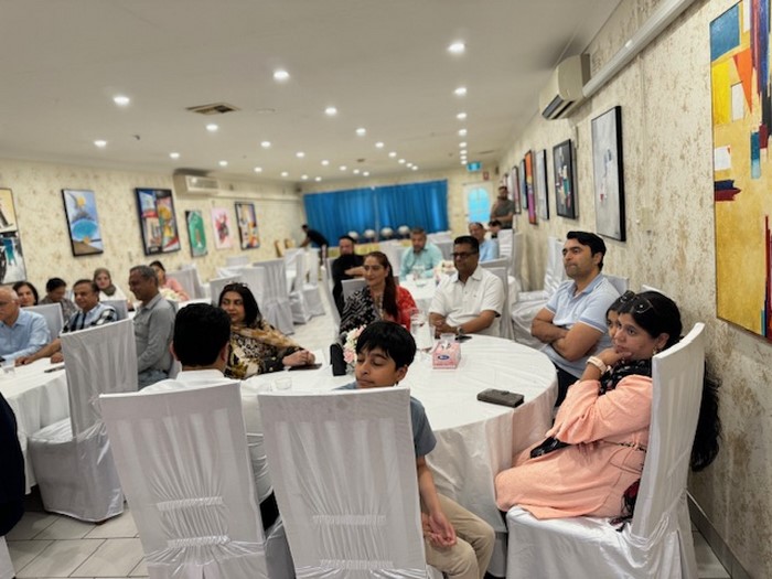 A group of people sitting at a table

Description automatically generated
