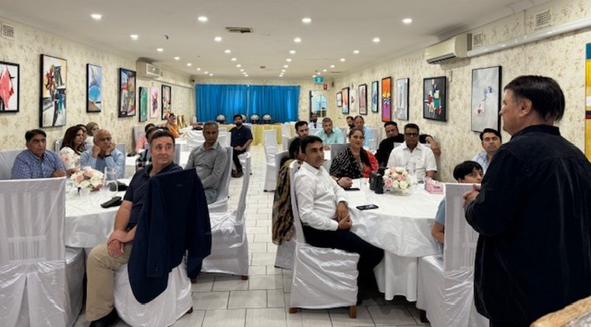 A group of people sitting at tables

Description automatically generated