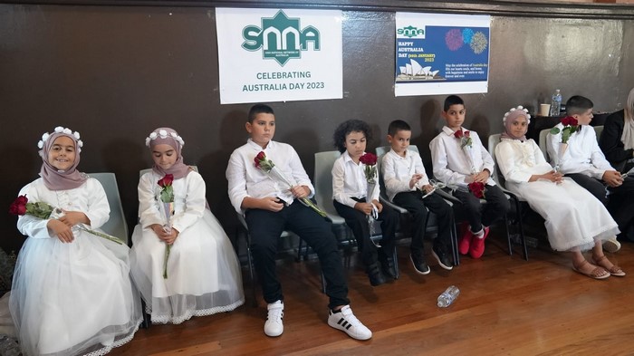 A group of children sitting in chairs

Description automatically generated