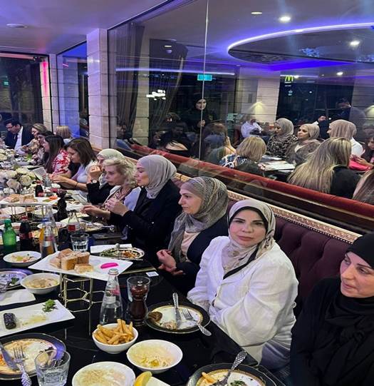 A group of women sitting at a table with food

Description automatically generated
