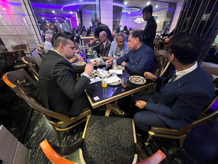 A group of people sitting around a table

Description automatically generated