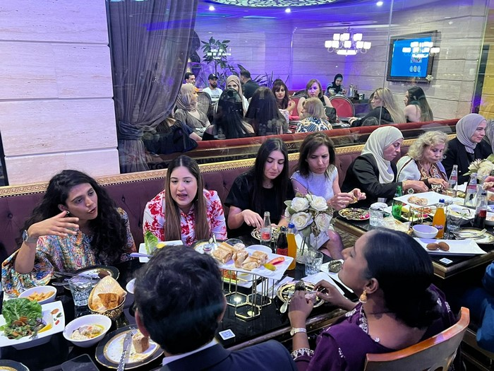 A group of people sitting around a table

Description automatically generated