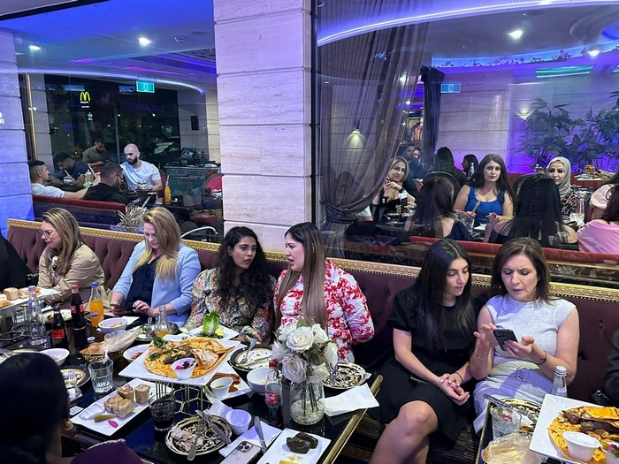 A group of people sitting at a table

Description automatically generated