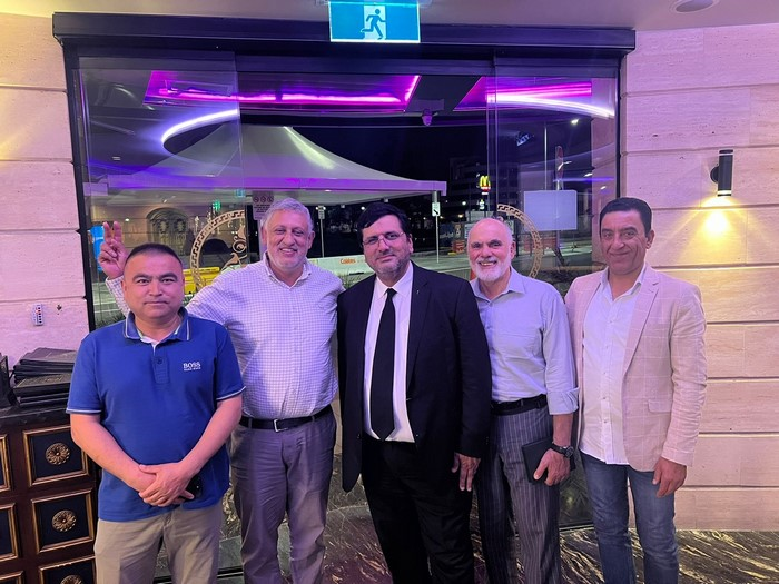 A group of men standing together

Description automatically generated