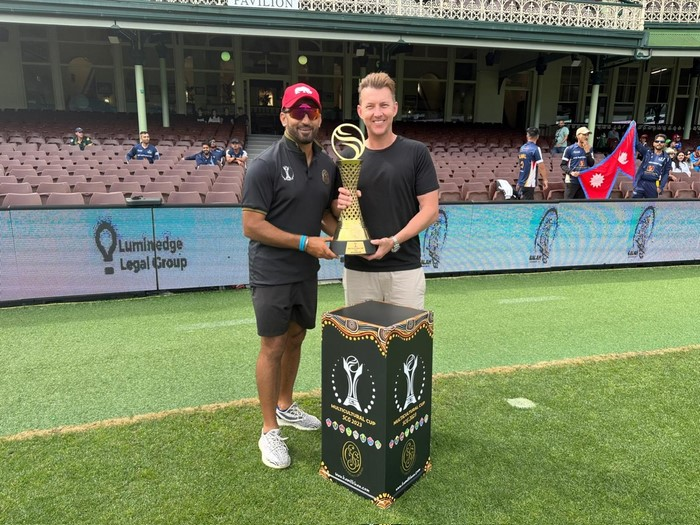 Two men holding a trophy
Description automatically generated