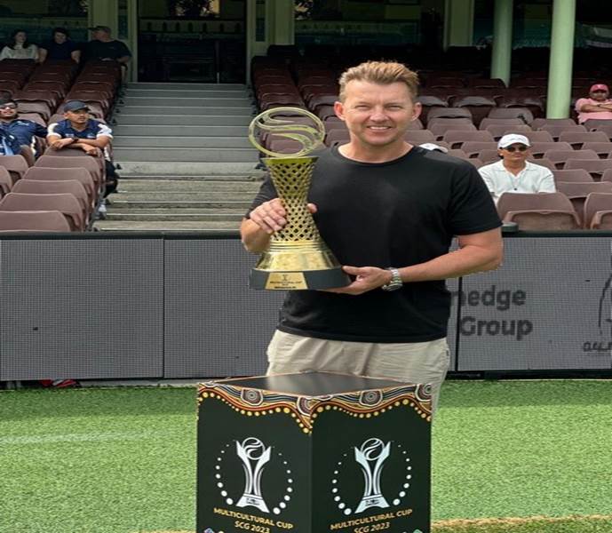 A person holding a trophy
Description automatically generated