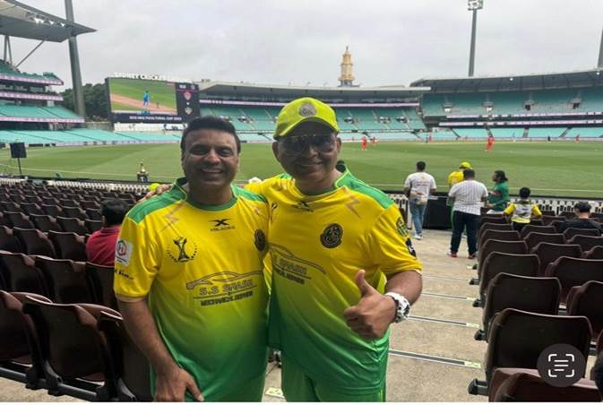 Two men in yellow and green uniforms standing in a stadium
Description automatically generated