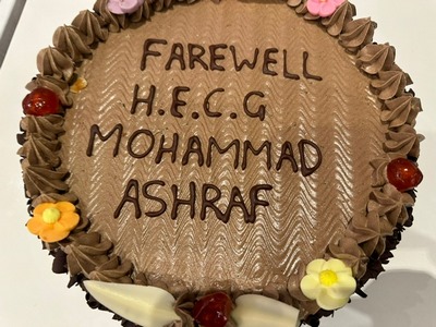 A cake with writing on it
Description automatically generated