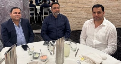 A group of men sitting at a table
Description automatically generated