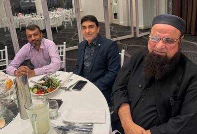 A group of men sitting at a table
Description automatically generated