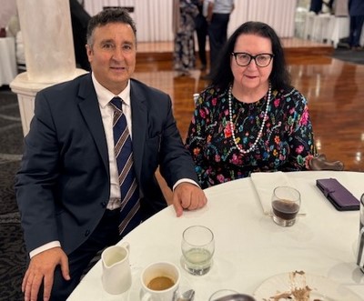 A person and person sitting at a table
Description automatically generated