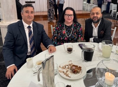 A group of people sitting at a table
Description automatically generated