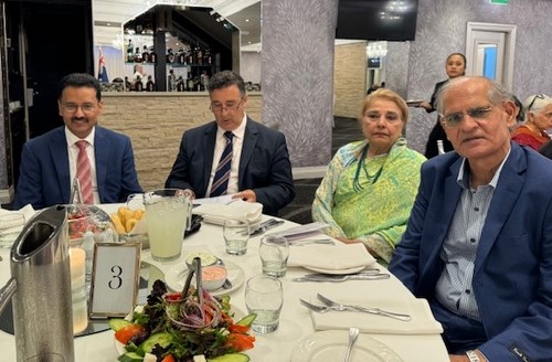 A group of people sitting around a table
Description automatically generated