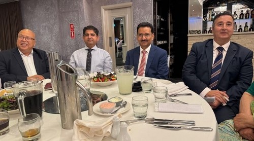 A group of men sitting at a table
Description automatically generated