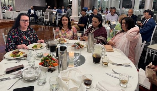 A group of people sitting at a table
Description automatically generated