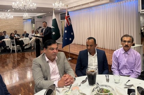 A group of men sitting at a table
Description automatically generated