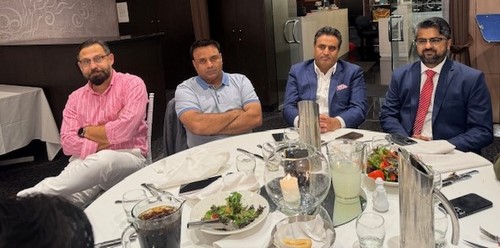 A group of people sitting at a table
Description automatically generated