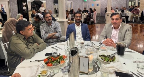 A group of people sitting at a table
Description automatically generated