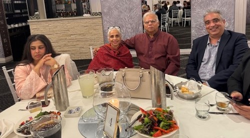 A group of people sitting at a table
Description automatically generated