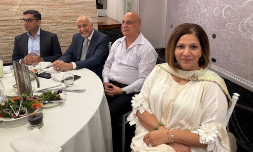 A group of people sitting at a table
Description automatically generated