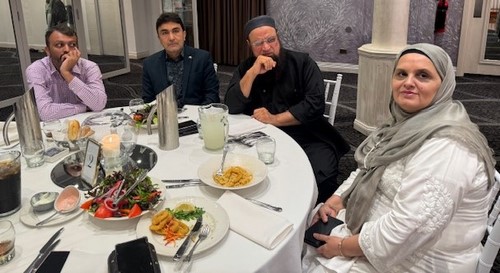A group of people sitting at a table
Description automatically generated