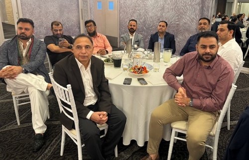 A group of men sitting at a table
Description automatically generated