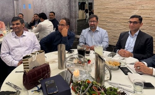 A group of men sitting at a table
Description automatically generated