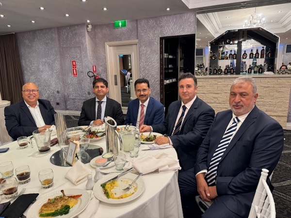 A group of men sitting at a table
Description automatically generated