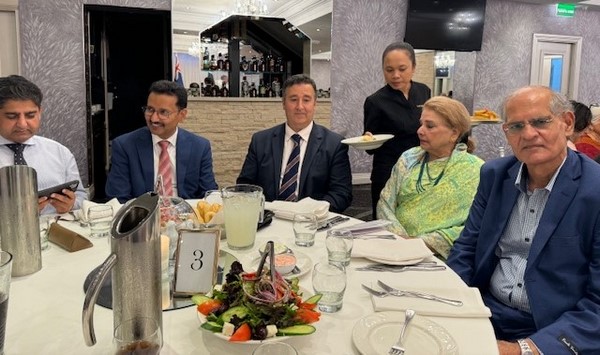 A group of people sitting at a table
Description automatically generated