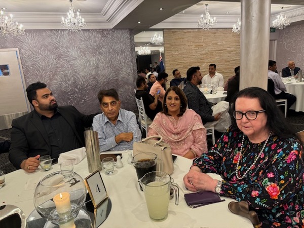 A group of people sitting at a table
Description automatically generated