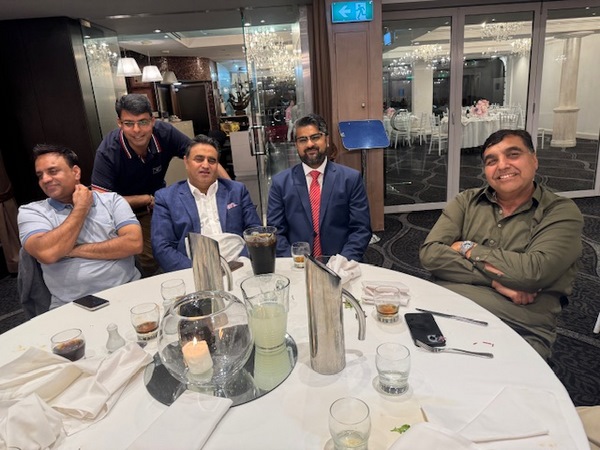 A group of men sitting at a table
Description automatically generated