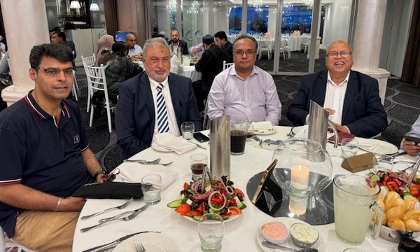 A group of men sitting at a table
Description automatically generated