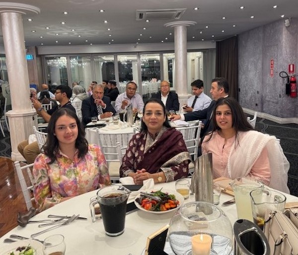 A group of people sitting at a table
Description automatically generated