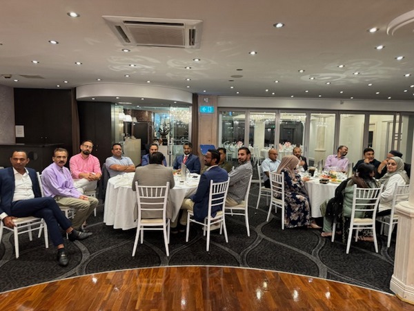 A group of people sitting around a table
Description automatically generated