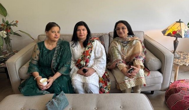 A group of women sitting on a couch
Description automatically generated