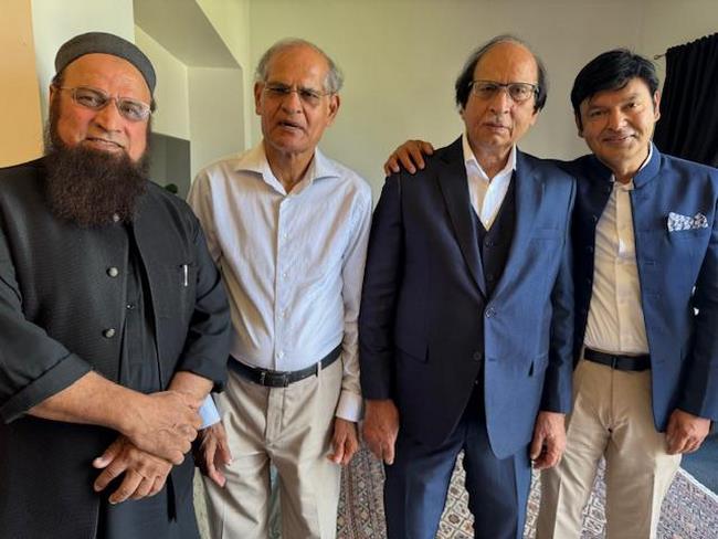 A group of men posing for a photo
Description automatically generated