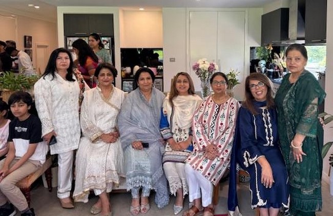 A group of women posing for a photo
Description automatically generated