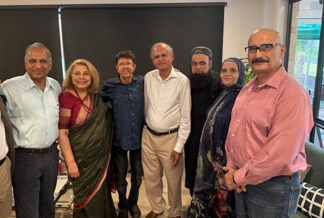 A group of people posing for a photo
Description automatically generated