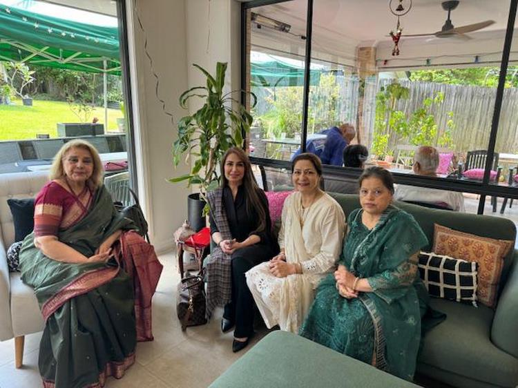 A group of women sitting on a couch
Description automatically generated