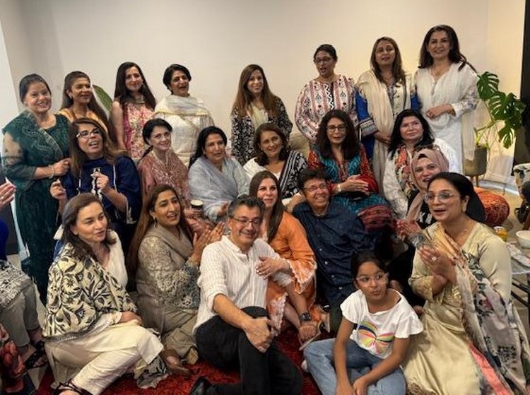 A group of people posing for a photo
Description automatically generated